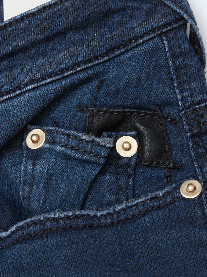 Close-up of the front pocket of Blue de Gênes Repi BlueBlk Used Jeans in blue-black comfort stretch denim, featuring a small coin pocket with black leather patch and brass rivets, highlighting the stitching and textured details.