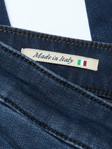 A close-up of Blue de Gênes Repi BlueBlk Used Jeans in blue-black denim, slim-fit with comfort stretch, showing a Made in Italy fabric tag and the Italian flag.