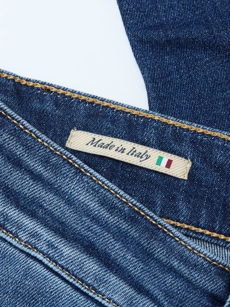 A close-up of Recco Blue Vintage Jeans - Vintage Wash by Blue de Gênes, featuring tapered legs and a label reading Made in Italy with the Italian flag.