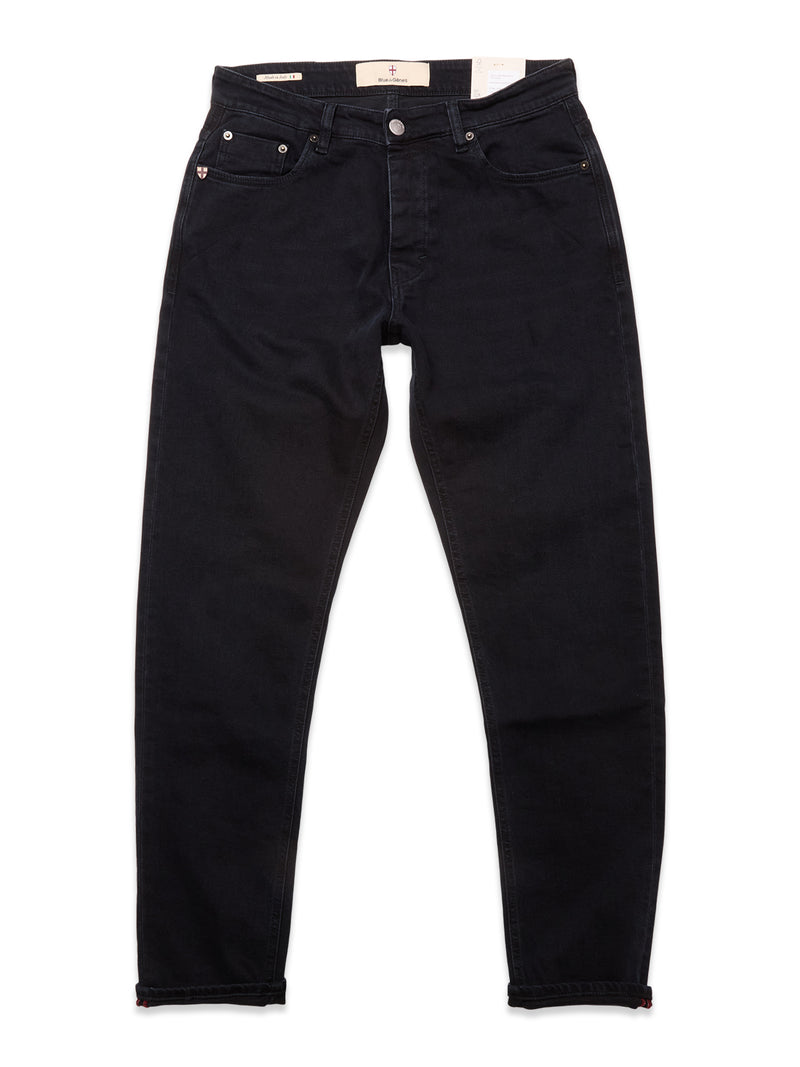 A pair of Blue de Gênes Recco BlueBlk Jeans in blue-black denim, laid flat on a white background, featuring front pockets, belt loops, button closure, and a relaxed regular fit with tapered legs.