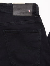 Close-up of the back pocket of Recco BlueBlk Jeans in blue black denim, with a black leather label above the pocket showing Blue de Gênes branding and a small white and red shield emblem.