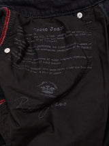 Close-up of the inside pocket of Blue de Gênes Recco BlueBlk Jeans in blue-black Italian denim, featuring printed brand and origin details, decorative stitching, and a signature.