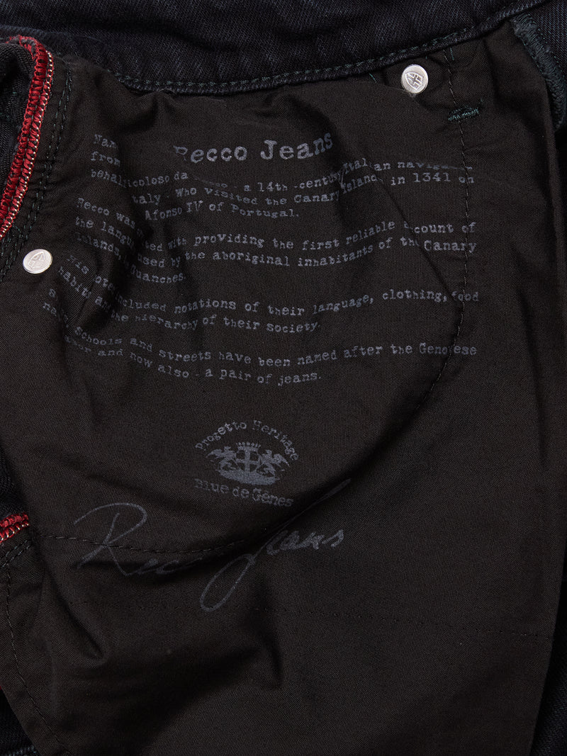 Close-up of the inside pocket of Blue de Gênes Recco BlueBlk Jeans in blue-black Italian denim, featuring printed brand and origin details, decorative stitching, and a signature.