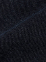 Close-up of the Blue de Gênes Recco BlueBlk Jeans in blue black denim, featuring a visible diagonal seam and intricate weave that highlight the premium texture of these tapered leg jeans.