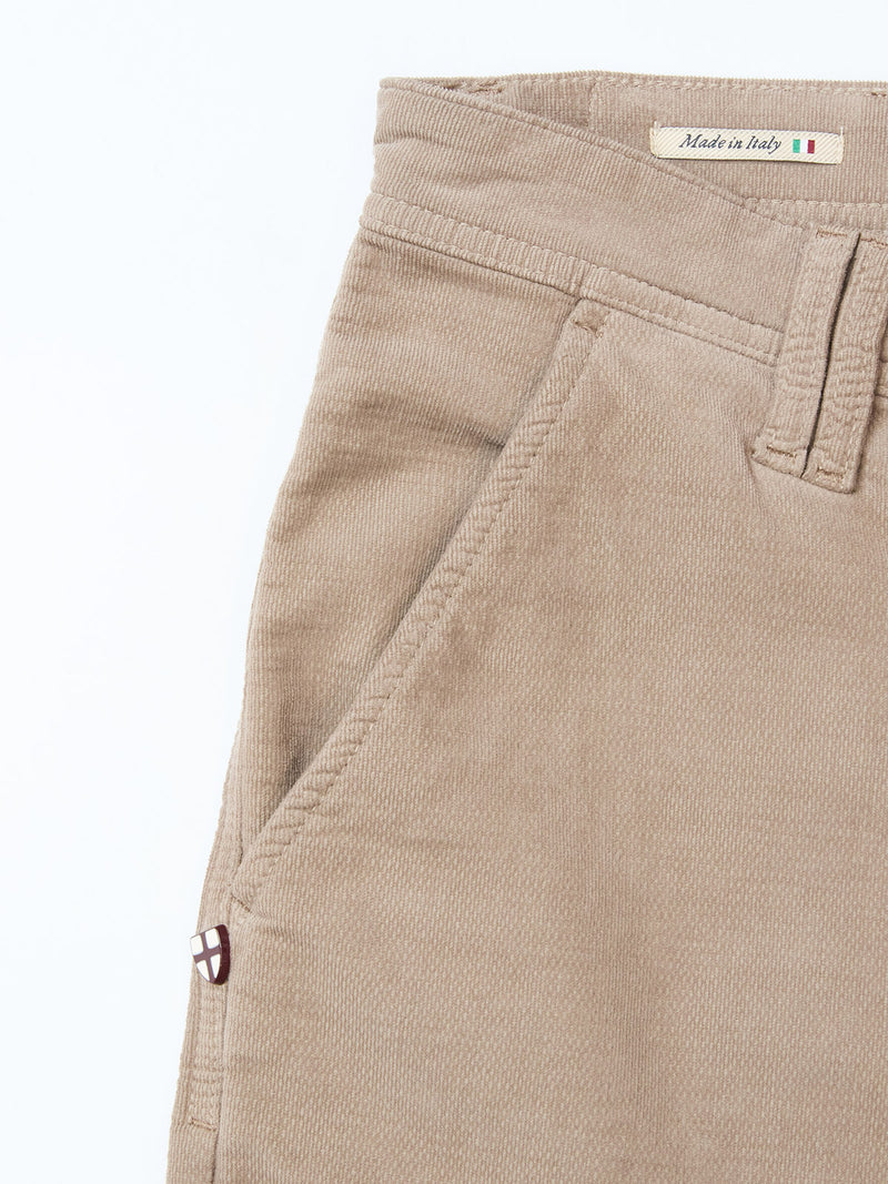 Close-up of Blue de Gênes BGpaulo Ottawa Trousers in Fungi, featuring light brown dobby corduroy fabric, front pocket, belt loop, and a Made in Italy label with an Italian flag on the inside waistband.