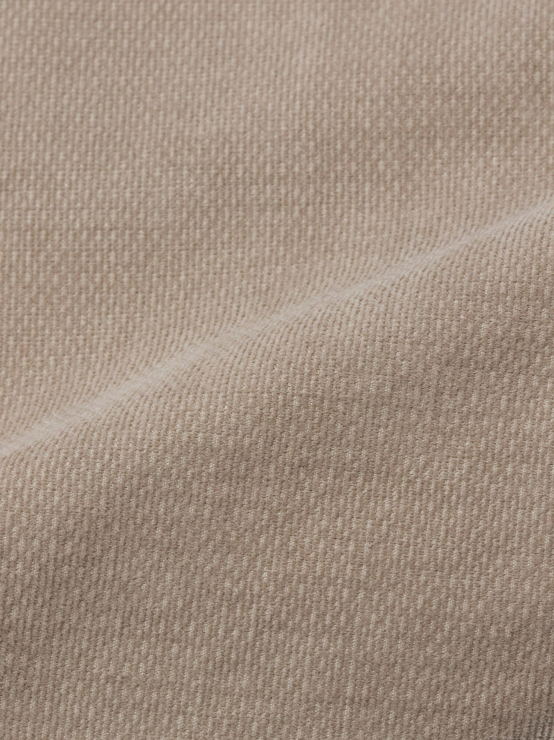 Close-up of the BGpaulo Ottawa Trousers - Fungi by Blue de Gênes shows beige dobby corduroy fabric with a diagonal seam, highlighting the weave and soft, textured surface—ideal for these premium Italian-made chinos.