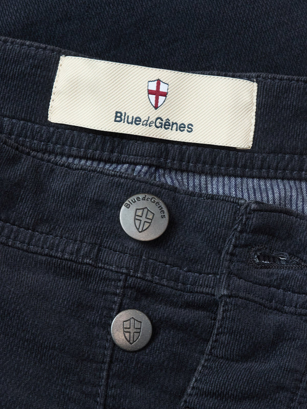 Close-up of BGpaulo Ottawa Trousers in Dark Navy by Blue de Gênes, featuring metal buttons and a cloth waistband label with the brand name and red and white shield logo. Made in Italy.