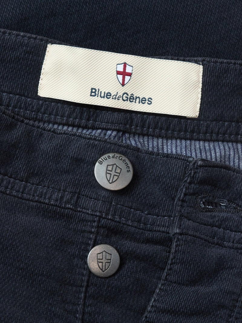 Close-up of BGpaulo Ottawa Trousers in Dark Navy by Blue de Gênes, featuring metal buttons and a cloth waistband label with the brand name and red and white shield logo. Made in Italy.