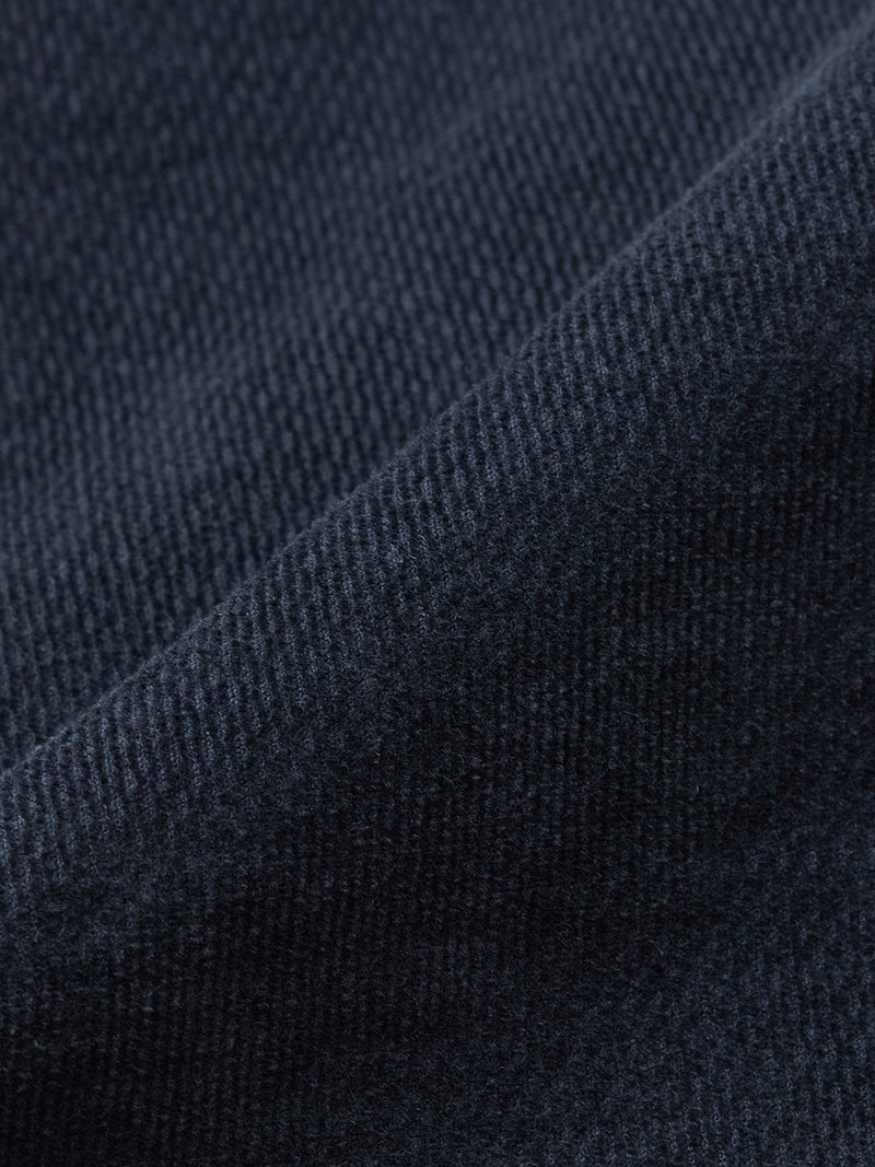 Close-up of dark navy textured fabric with visible weave and soft folds, reminiscent of the luxurious material used in Blue de Gênes BGpaulo Ottawa Trousers, made in Italy.