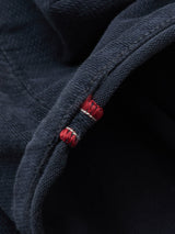 Close-up of dark blue denim fabric with a visible selvedge edge and red-white stitched stripe, highlighting texture and premium craftsmanship, as seen in Blue de Gênes BGpaulo Ottawa Trousers - Dark Navy.