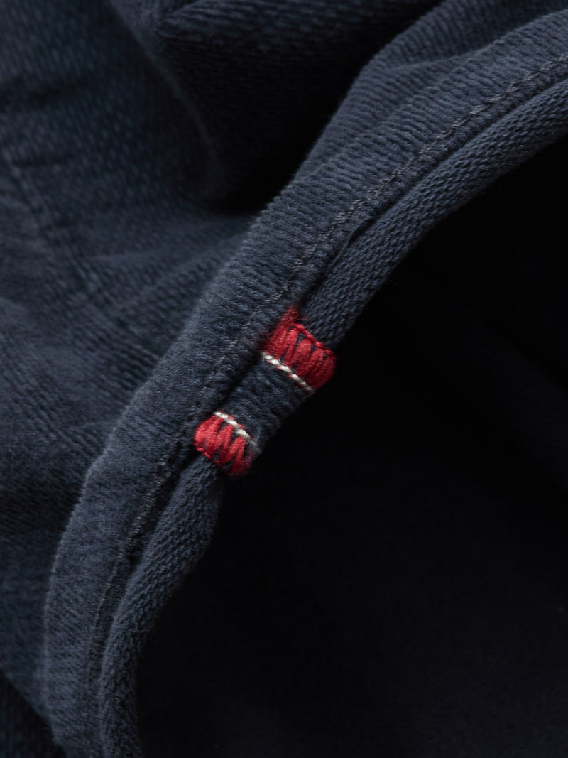 Close-up of dark blue denim fabric with a visible selvedge edge and red-white stitched stripe, highlighting texture and premium craftsmanship, as seen in Blue de Gênes BGpaulo Ottawa Trousers - Dark Navy.