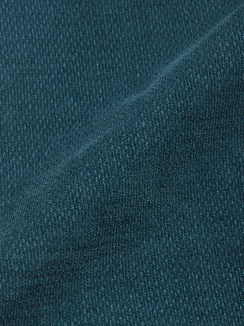 Close-up of BGpaulo Ottawa Trousers - Dark Slate by Blue de Gênes, highlighting the soft, textured dobby corduroy fabric with visible woven fibers and a gentle diagonal shadow from a subtle fold in the material.