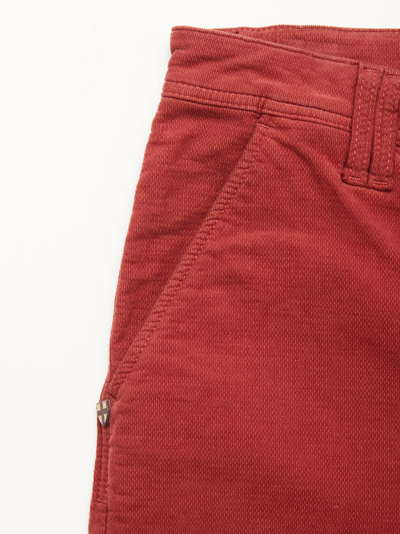 Close-up of the upper section of BGpaulo Ottawa Trousers in Henna by Blue de Gênes, showing a belt loop, side pocket, and visible seam details against a white background.