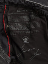Close-up of the inside label on Blue de Gênes Giacomo BLK Used Jeans - Grey Denim, showing white heritage text, visible stitching, and red trim—crafted from rigid denim and made in Italy.