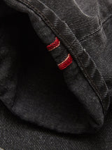 Close-up of the cuff on Blue de Gênes Giacomo BLK Used Jeans in grey denim, featuring a folded hem with red and white selvedge stitching detail.