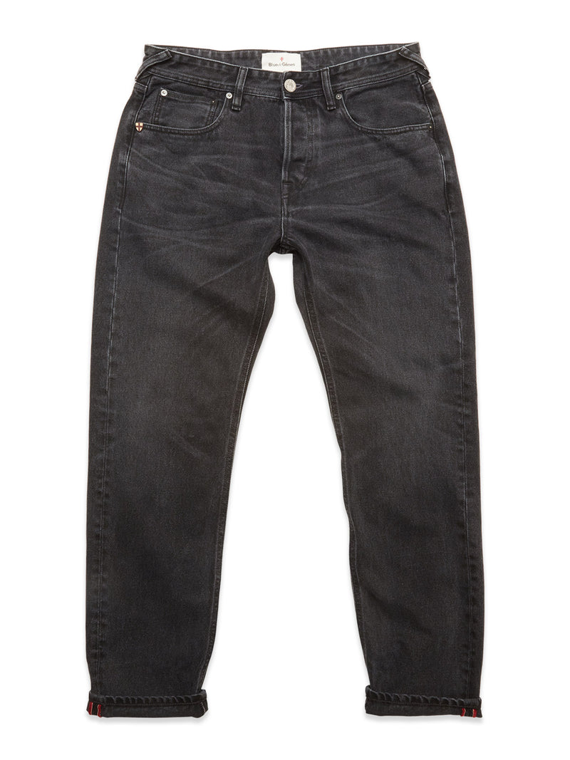 The Blue de Gênes Giacomo BLK Used Jeans in grey denim feature a classic five-pocket design, button and zip closure, and slightly tapered legs. Expertly crafted in Italy for timeless style and quality. Shown laid flat on a white background.
