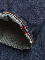 A close-up of the cuff on Blue de Gênes Giacomo Dark Horse Jeans in Denim Blue showcases the inside seam with distinctive white and red selvedge edge and contrasting orange stitching.