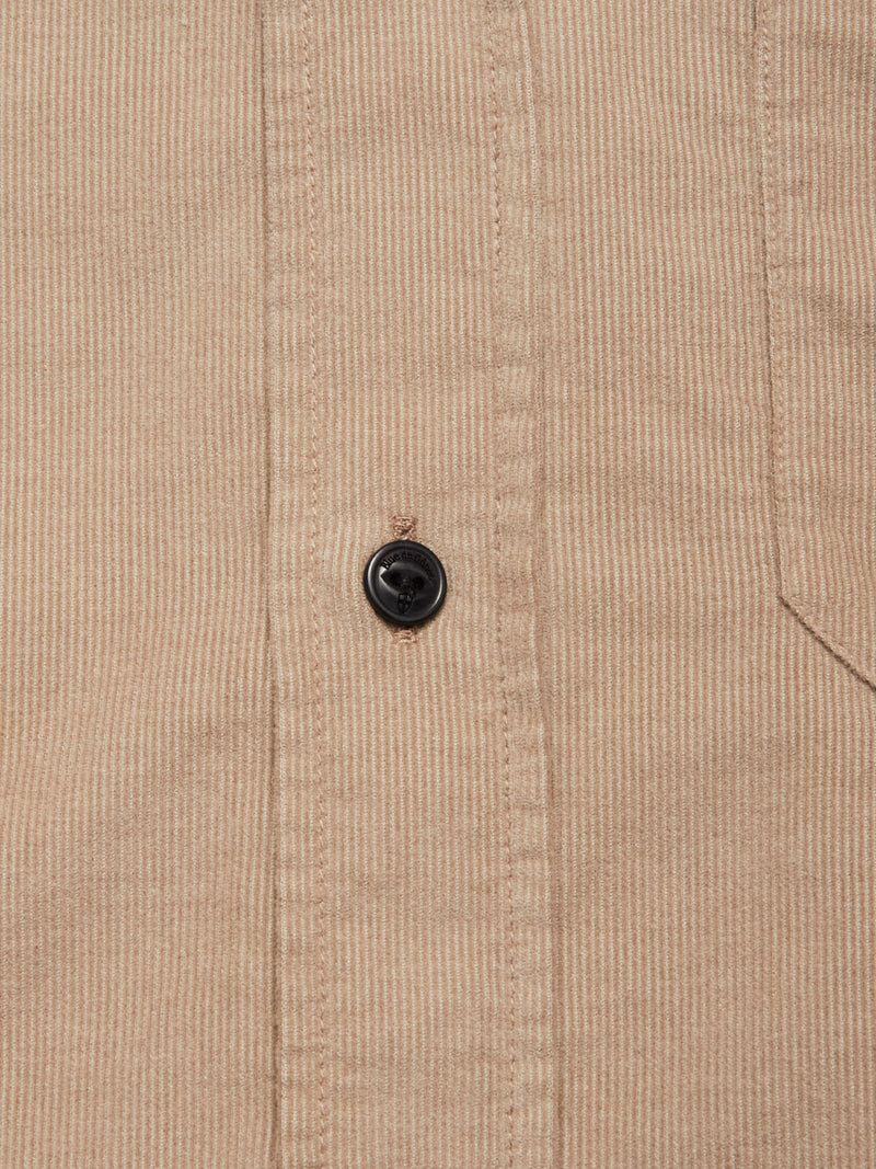 Close-up of the Blue de Gênes Zamboni Velu Shirt - Fungi, featuring garment-dyed baby corduroy with fine vertical ridges, a black button, and a partial view of the right chest pocket.
