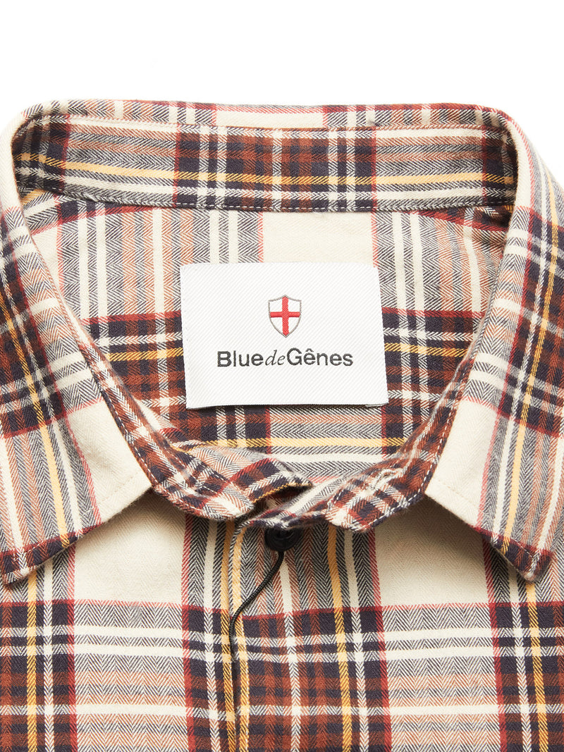 Close-up of the Robertino Brush Shirt - Stone by Blue de Gênes, featuring a beige, brown, and red brushed collar with a blue brand label, made in Portugal, and a red and white shield logo inside.