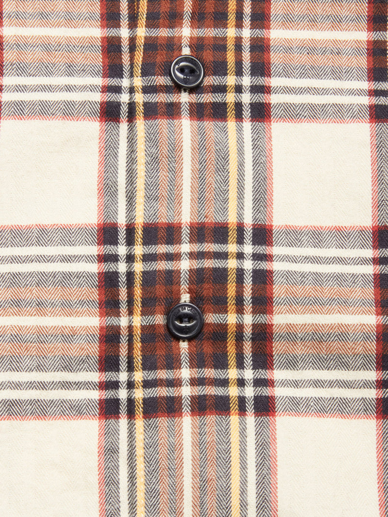 Close-up of the Blue de Gênes Robertino Brush Shirt - Stone, crafted from Sidogras cotton with a cream, brown, red, and yellow plaid design and two black buttons aligned vertically at the center.
