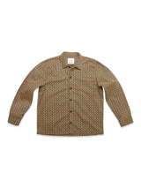 The Blue de Gênes Manga Overshirt in a black geometric pattern features long sleeves, a button-up front, spread collar, and straight hem. This versatile cotton overshirt is displayed flat on a white background.