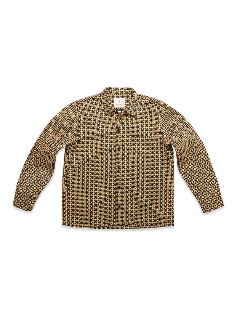 The Blue de Gênes Manga Overshirt in a black geometric pattern features long sleeves, a button-up front, spread collar, and straight hem. This versatile cotton overshirt is displayed flat on a white background.