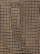 Close-up of the Massone Check Coat - Multi Check by Blue de Gênes, featuring brown and black houndstooth-patterned Melton wool with a seamlessly hidden pocket.