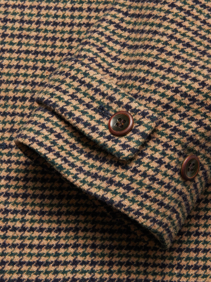 A close-up of the Massone Check Coat - Multi Check by Blue de Gênes in beige and dark green houndstooth Melton wool, showing the cuff with two brown buttons.