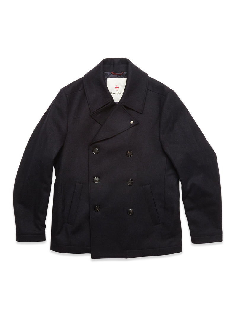 The Blue de Gênes Shiba Melton Coat - Dark Navy is a classic peacoat with a double-breasted front, wide notched collar, and black buttons, expertly crafted from Italian Melton wool and shown on a white background.