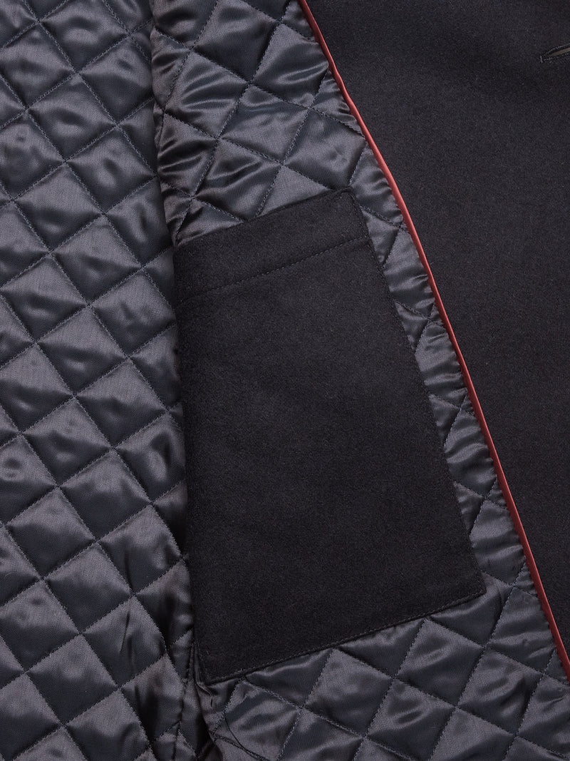 Close-up of the Shiba Melton Coat - Dark Navy by Blue de Gênes: features a quilted, diamond-patterned lining, black inner pocket, and red piping, showcasing shiny texture and premium craftsmanship.