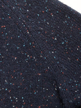 Close-up of the Honshu Crewneck Knit in Navy by Blue de Gênes, showing the chunky lambswool blend with a speckled pattern of red, white, and blue flecks. The knit’s texture and stitching are clearly visible.