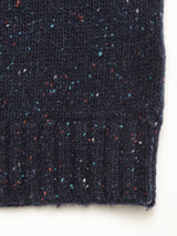 Close-up of the Honshu Crewneck Knit in Navy by Blue de Gênes, featuring chunky lambswool blend yarn with colorful red, white, and blue flecks and a ribbed edge that highlights its textured knit.