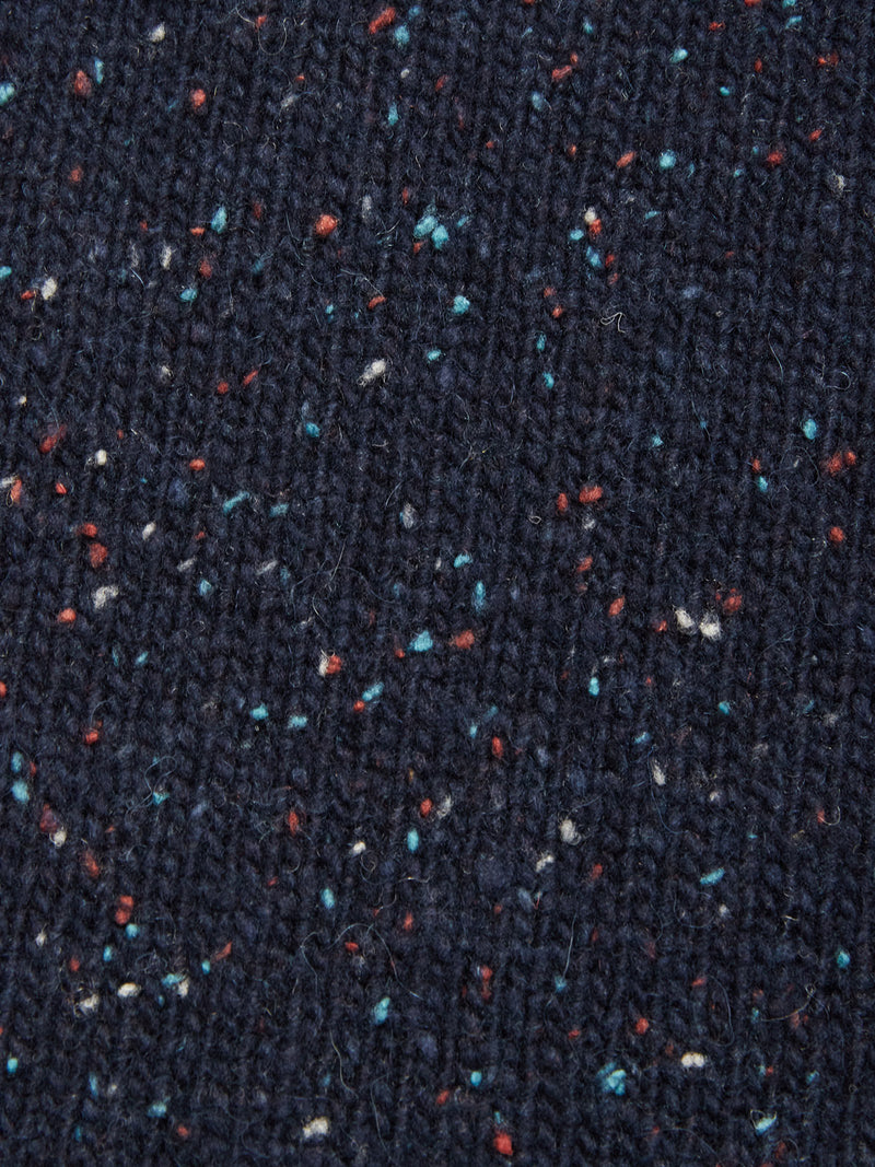 Close-up of the Honshu Crewneck Knit - Navy by Blue de Gênes, featuring chunky dark blue lambswool blend fabric with subtle red, white, and blue flecks throughout.
