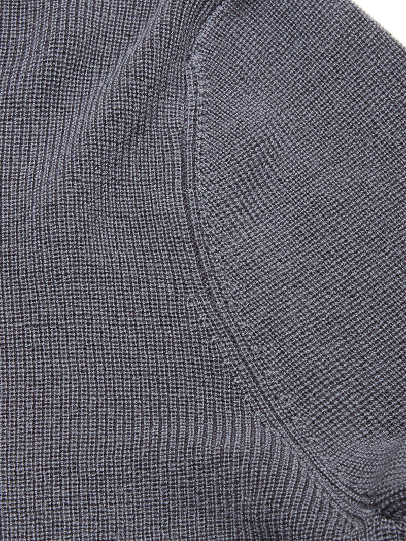 Close-up of the Porto Knit - Dark Slate by Blue de Gênes, showing textured 100% wool fabric with visible stitching, waffle-knit pattern, and curved edge—ideal for classic menswear style.