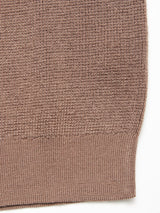 Close-up of the Porto Knit - Fungi by Blue de Gênes, showcasing its soft, finely woven 100% wool brown textured fabric and ribbed hem, ideal for menswear crewneck sweaters.