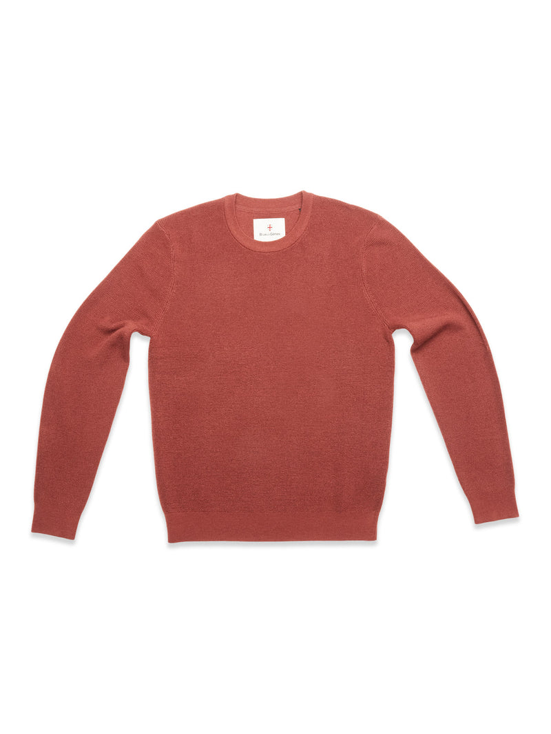 The Blue de Gênes Porto Knit - Henna is a crewneck, long-sleeve sweater in a muted reddish-brown shade, ideal for menswear fans and shown laid flat on a white background. Inspired by the timeless style of Blue de Gênes.