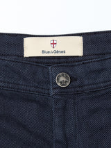 Close-up of the dark blue jeans’ waistband with a silver button and Blue de Gênes label, styled perfectly with the Menzo Olanda Chino - Navy for a refined look.
