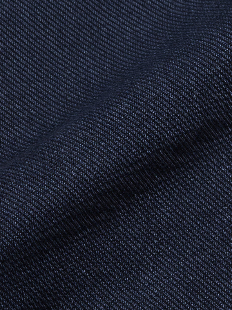 Close-up of a dark blue, textured fabric with a diagonal weave—perfect for cotton blend chinos or the refined Menzo Olanda Chino by Blue de Gênes, known for its signature tapered leg.