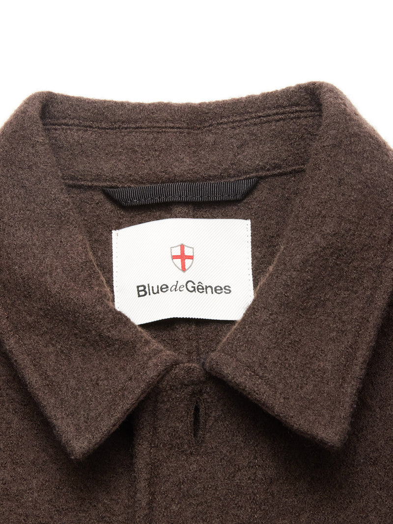 Close-up of the chocolate boiled wool Kojima Wool Jacket collar, featuring a white Blue de Gênes label with a red cross emblem, capturing the classic overshirt style.