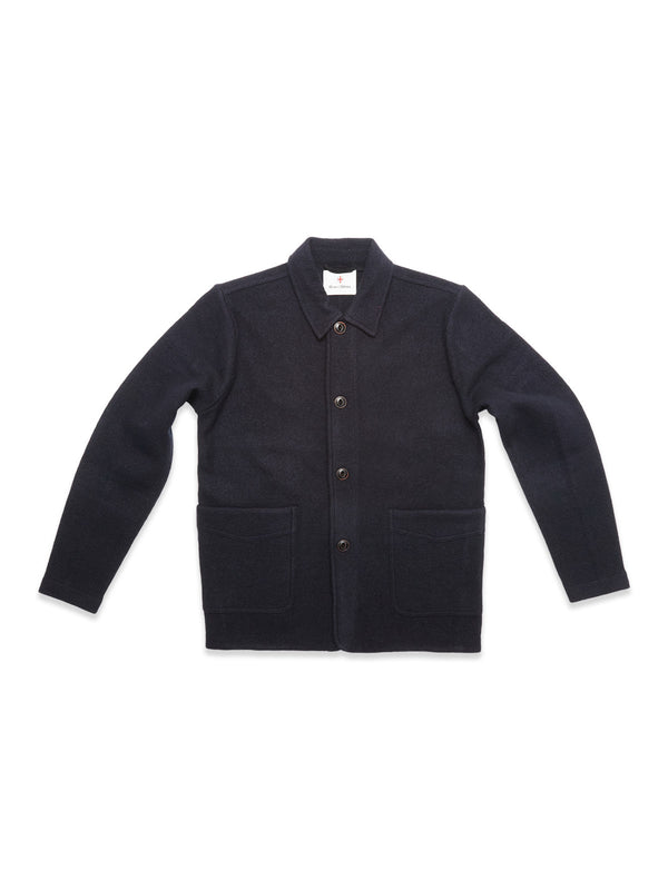 The Blue de Gênes Kojima Wool Jacket - Navy, made from soft boiled wool with a collar, button-down front, long sleeves, and two large front pockets, is shown laid flat on a white background.