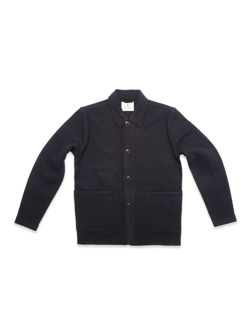 The Blue de Gênes Kojima Wool Jacket - Navy, made from soft boiled wool with a collar, button-down front, long sleeves, and two large front pockets, is shown laid flat on a white background.