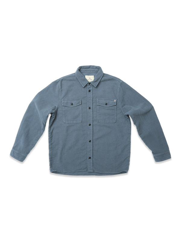 The Blue de Gênes Nagano Overshirt in Dark Slate is a long-sleeve, button-up garment dyed cotton Moleskin shirt with two chest pockets and a collar, shown laid flat on a white background.