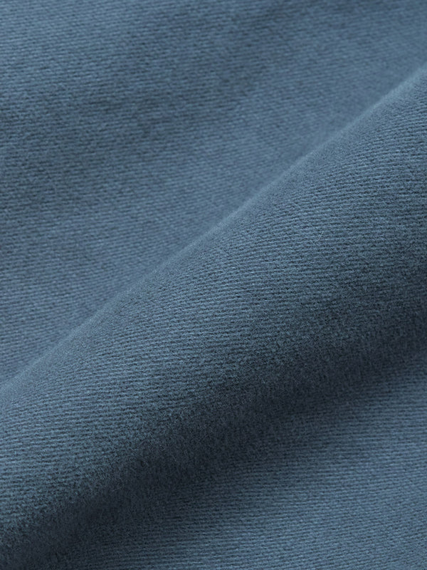 Close-up of the Nagano Overshirt - Dark Slate by Blue de Gênes, highlighting its soft, textured cotton fabric with a visible diagonal fold.