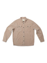 The Blue de Gênes Nagano Overshirt - Fungi is a beige cotton moleskin long-sleeve button-up with black buttons, two chest pockets, visible stitching, and a garment-dyed finish, shown laid flat on a white background.