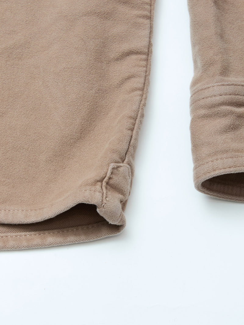 Close-up of the Blue de Gênes Nagano Overshirt - Fungi in garment-dyed cotton moleskin, featuring detailed side seam, hem, and sleeve cuffs against a white background.