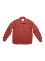 The Blue de Gênes Nagano Overshirt in Henna is a long-sleeve, button-up shirt made from soft Moleskin cotton, garment-dyed for rich color, with two chest pockets and shown flat on a white background.