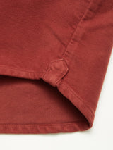 Close-up of the hem and side slit of the Blue de Gênes Nagano Overshirt - Henna in Moleskin cotton, highlighting detailed stitching and a reinforced corner.