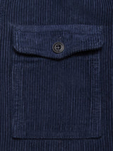 Close-up of the Blue de Gênes Masami Cord Blazer - Navy, garment dyed for rich color. Its corduroy fabric has vertical ridges, a patch pocket with flap and black button, emphasizing this stylish textured piece.