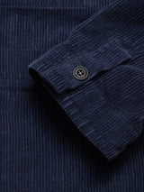 Close-up of the Masami Cord Blazer by Blue de Gênes in navy, featuring garment-dyed corduroy with visible vertical ridges and a black cuff button.