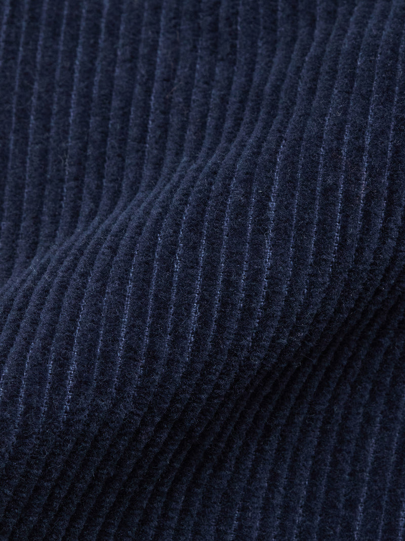 Close-up of Blue de Gênes Masami Cord Blazer - Navy fabric, highlighting its vertical corduroy ridges, soft texture, and deep navy hue. Garment-dyed for rich color and showcasing quality craftsmanship.